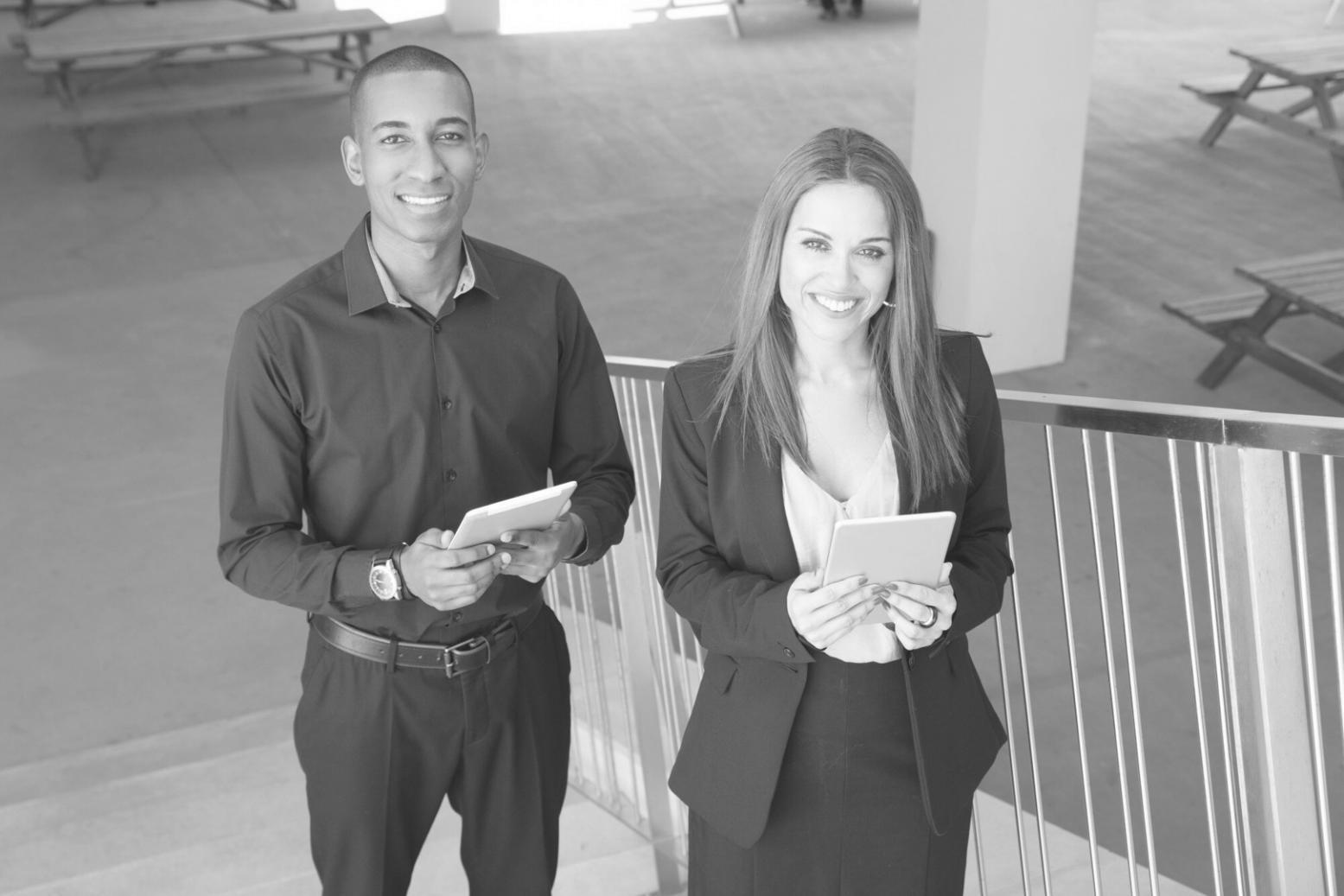 Modern workspace setup with dual monitors displaying trading charts and psychological tracking tools